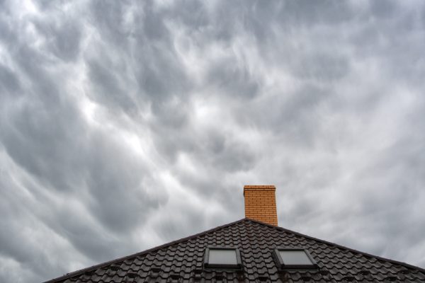 Roof of a detached house  chimney against the sky