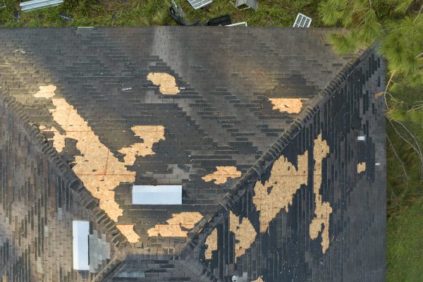 Natural disaster and its consequences. Hurricane Ian destroyed house roof in Florida residential area.